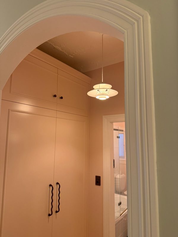 A pendant light hung inside an arched doorway