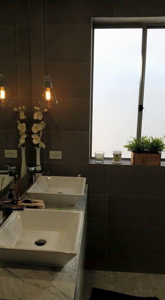 Filament bulb pendants hanging above twin bathroom basins
