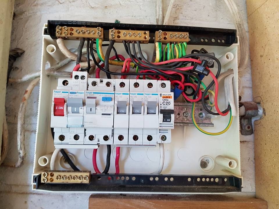 A switchboard with its cover off showing neat wiring to each breaker