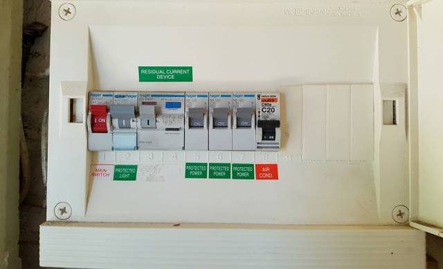 A switchboard with a main switch, safety switches and labelled circuit breakers
