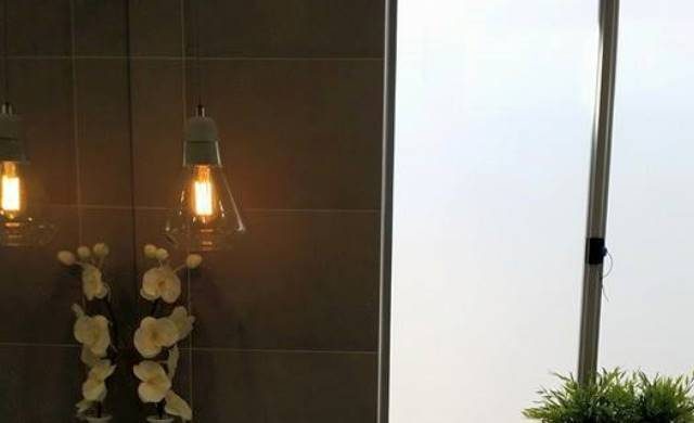 Filament pendant lights against a dark tiled wall