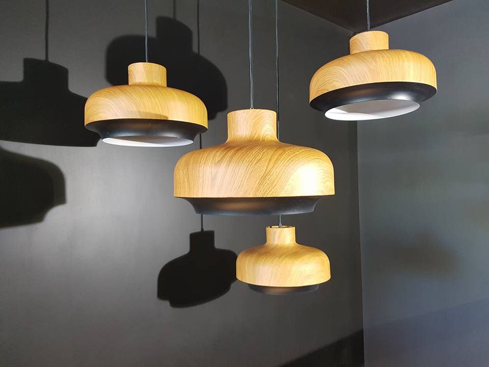 Three timber-look pendant lights hung at staggered heights