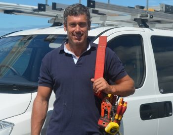 Peter Stafford, owner of Ambient Electrical, beside his work van