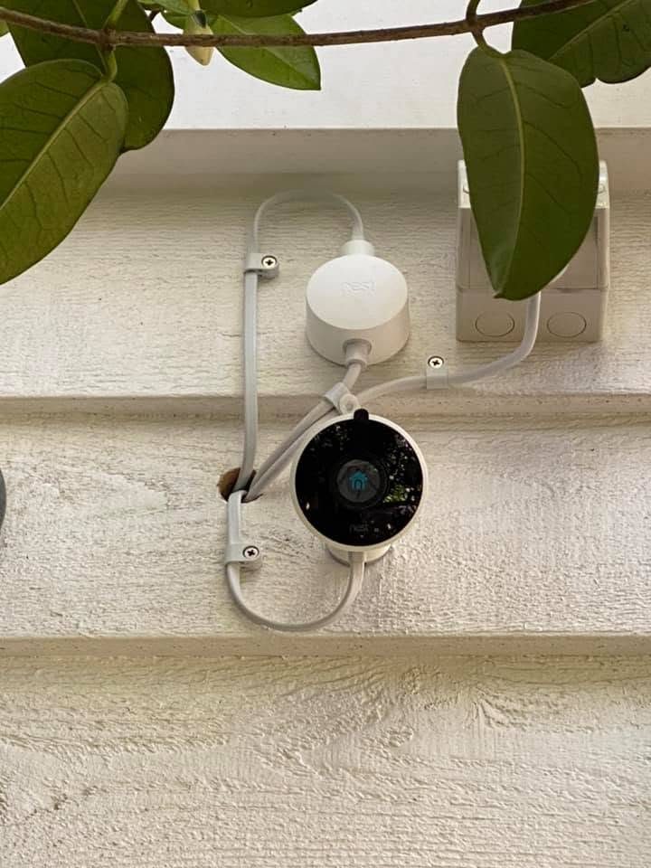 A security camera mounted on weatherboard cladding